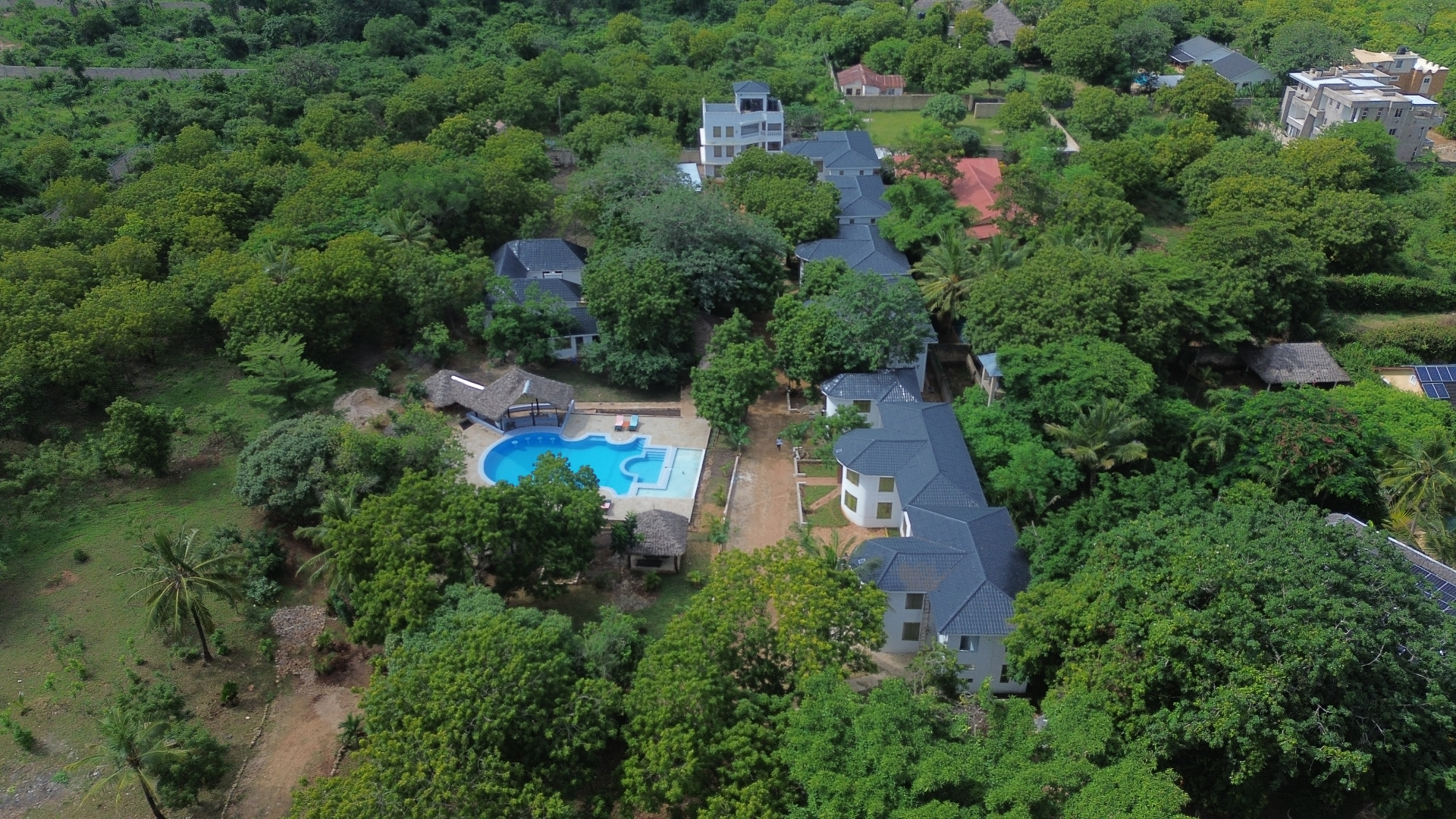 Aerial view of Musituni Luxury Villas swimming pool with thatched cabanas
